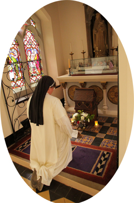 A Sister kneels at St Catherine's Shrine, where arelic of St catherine is preserved.